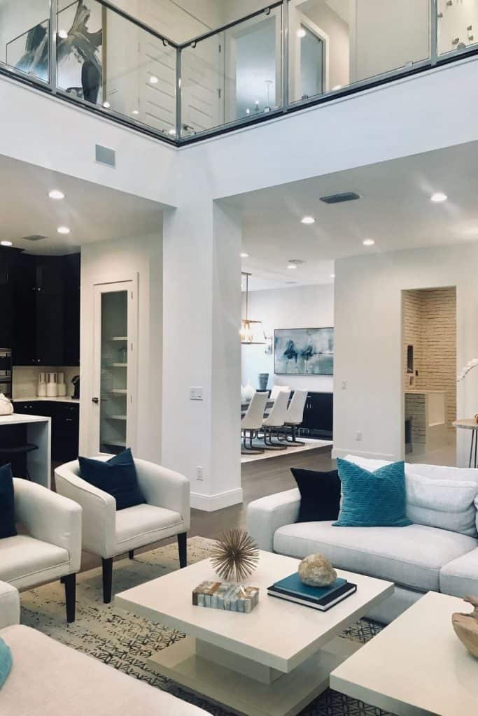 Modern Home with couch and two armchairs. Throw pillows are blue to add color.