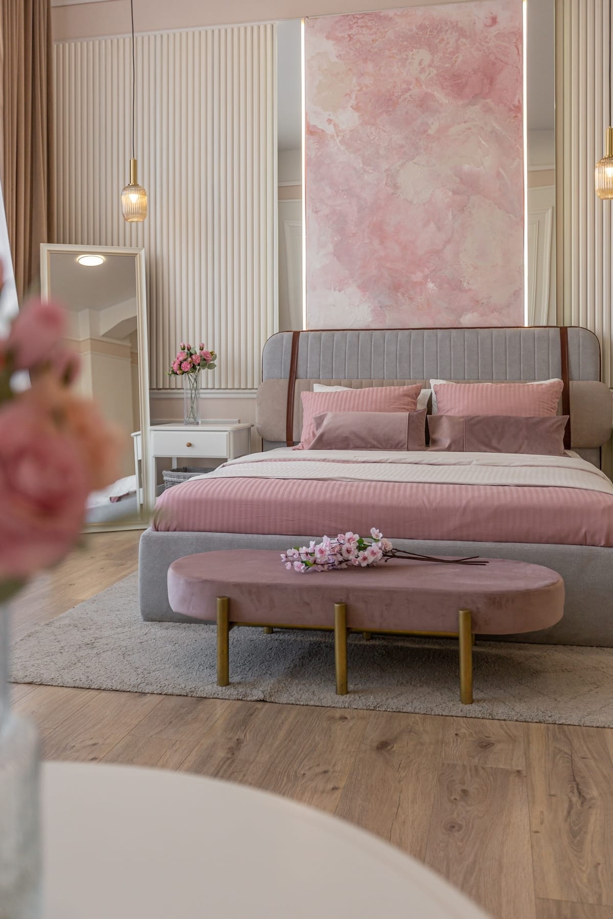 a close view of the bedroom in a modern cozy soft interior in warm delicate pastel pink and beige colors
