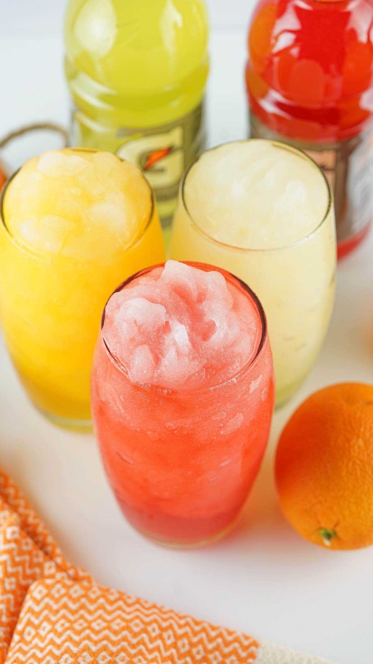 Close-up of three Gatorade slushies in red, yellow, and pale yellow.